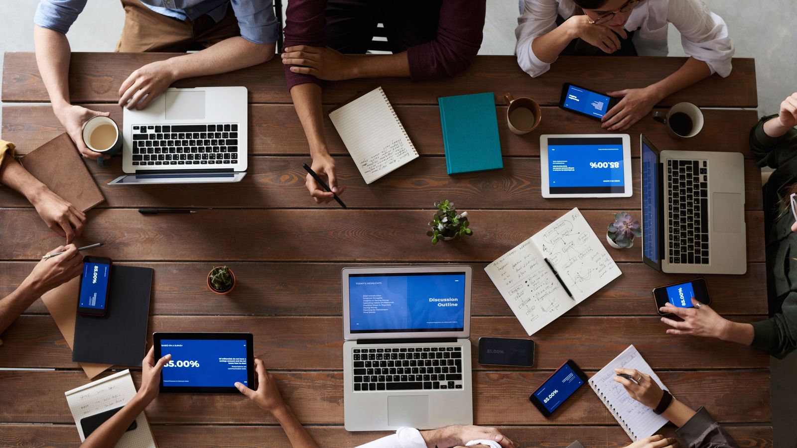 Developers collaborating around laptops during a working session